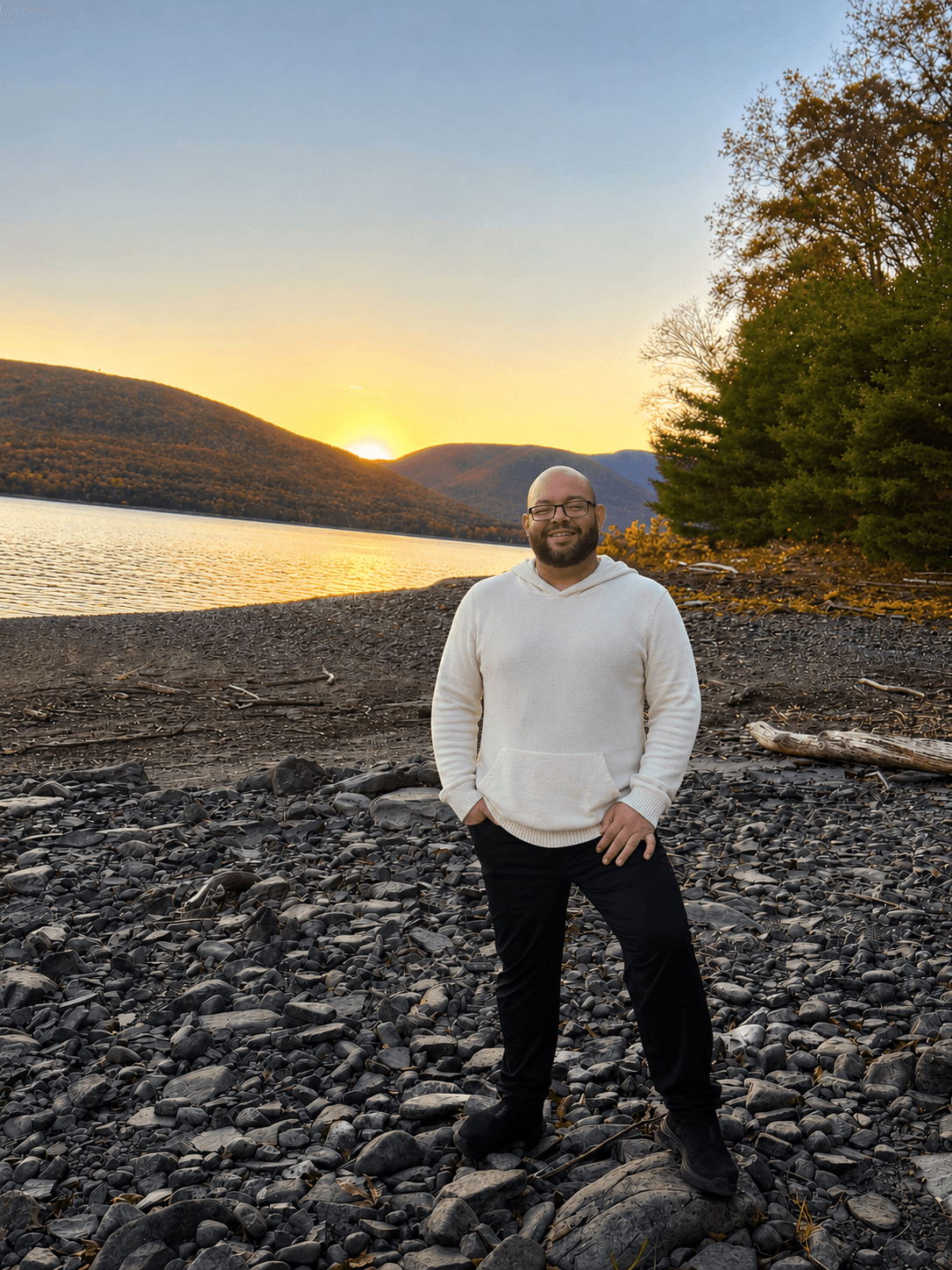 Felix Garcia Tirado, founder of Uverali, standing beside a lake at sunset